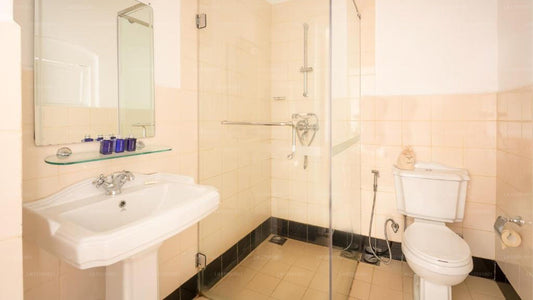 Bathroom with sink, toilet, and shower area.